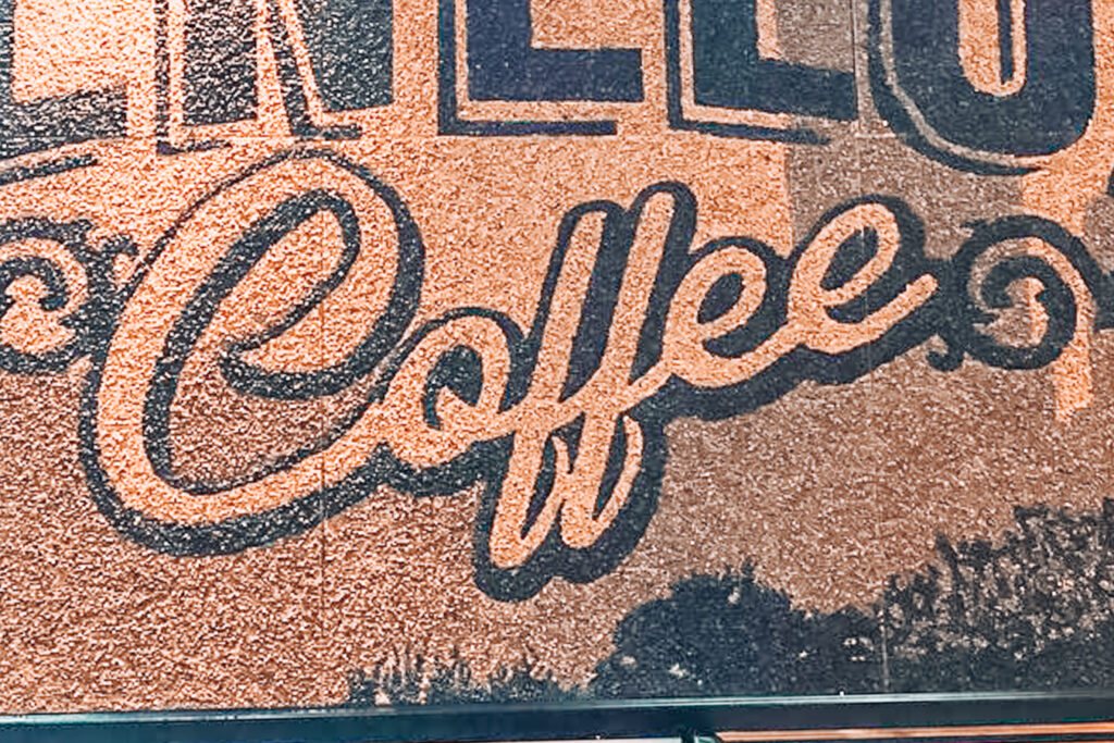 Wall with a sign at Benelux Cafe, one of the best coffee shops in Raleigh, NC